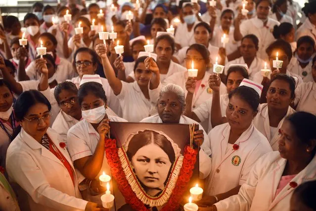 Nurses and medical staff members take part in a candlelight vigil to mark International Nurses Day to honor the birth anniversary of the founder of modern nursing, Florence Nightingale, at Omandurar government hospital, in Chennai, India, 12 May 2022. International Nurses Day is observed every year on May 12 to commemorate the birthday of the founder of modern nursing, Florence Nightingale, and to honor nurses across the world for their contribution to the medical sector. (Photo by Idrees Mohammed/EPA/EFE)