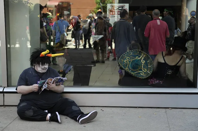 A convention attendee takes a break during Denver Comic Con at the Colorado Convention Center in Denver, Colorado on June 14, 2014. (Photo by Seth McConnell/The Denver Post)