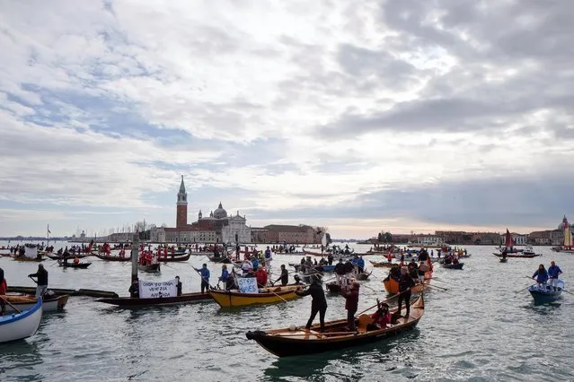Scores of boats take to the Saint Mark's Basin, as Venetians protest against the damage caused by big ships, in Venice, Italy on January 19, 2020. (Photo by Manuel Silvestri/Reuters)