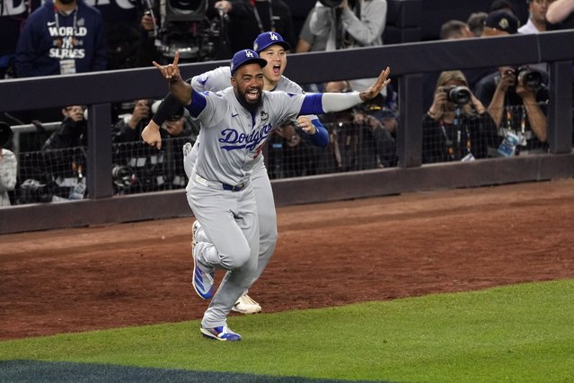 Los Angeles Dodgers' Teoscar Hernández (37) and Shohei Ohtani celebrate after the Dodgers beat the New York Yankees in Game 5 to win the baseball World Series, Wednesday, October 30, 2024, in New York. (Photo by Seth Wenig/AP Photo)