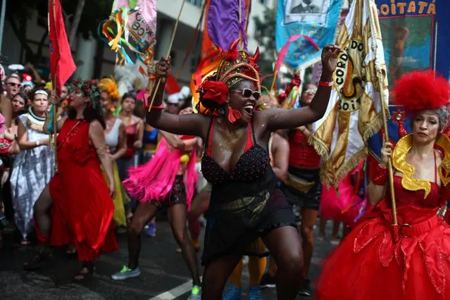 A reveller dances at the annual block party known as “Cordao de Boitata”, during Carnival festivities in Rio de Janeiro, Brazil on February 16, 2020. (Photo by Pilar Olivares/Reuters)