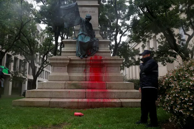 Red paint is seen splattered on the base of a statue of Confederate General Albert Pike during a demonstration calling for its removal in Washington, U.S., August 18, 2017. (Photo by Aaron P. Bernstein/Reuters)