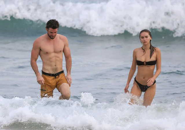 Liam Hemsworth shows off his ripped beach bod during a morning swim with bikini-clad girlfriend Gabriella Brooks in Byron Bay, Australia on March 9, 2020. (Photo by Media-Mode/Splash News and Pictures)