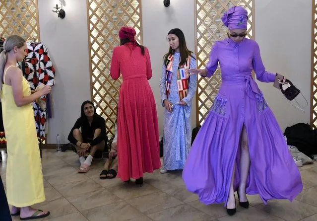 Models prepare themselves backstage, during the World Nomads Fashion festival Issyk-Kul 2022, at Cholpon-Ata, a resort town on the northern shore of Lake Issyk-Kul, 207 kilometers (129 miles) east of Bishkek, Kyrgyzstan, Saturday, July 23, 2022. On the shore of one of the world's largest lakes, high up in Kyrgyzstan's Tian Shan mountains, models strutted and sashayed in outfits mixing the ancient and modern at the World Nomads Fashion festival. (Photo by Vladimir Voronin/AP Photo)