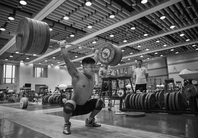 Chinese weightlifter Lu Xiaojun, who competes in the 77 kg weightclass, lifts during a training session in preparation for the Rio Olympics at the Training Center of General Administration of Sports in China on July 20, 2016 in Beijing, China. (Photo by Kevin Frayer/Getty Images)