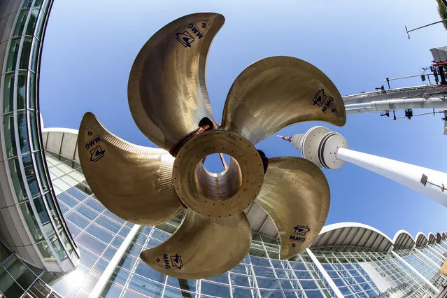 A ship propeller which weighs 82 tons is installed in front of a fair hall in Hamburg, Germany, September 4, 2014. The propeller is the eyecathing item for the marine fair SMM (Shipbuilding, Machinery & Marine Technology fair) which takes place from 09 to 12 September 2014. Around 2,000 exhibitors will present their latest developments and the new trends of the maritime world. (Photo by Ulrich Perrey/EPA)