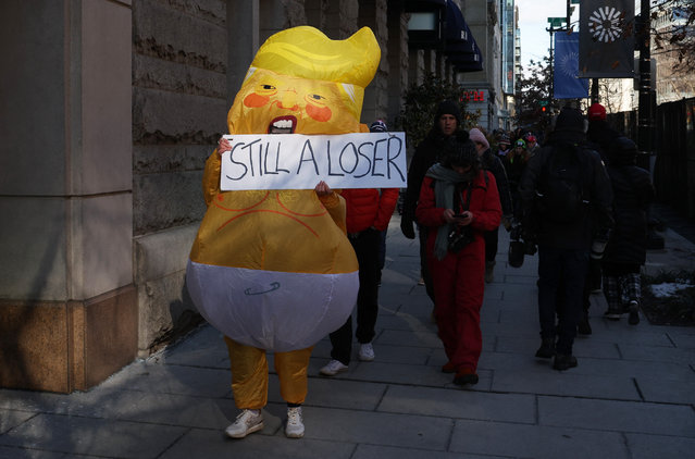 A protester wears an inflatable President Donald Trump costume and displays a “still a loser” banner on the inauguration day of Donald Trump's second presidential term in Washington on January 20, 2025. (Photo by Marko Djurica/Reuters)