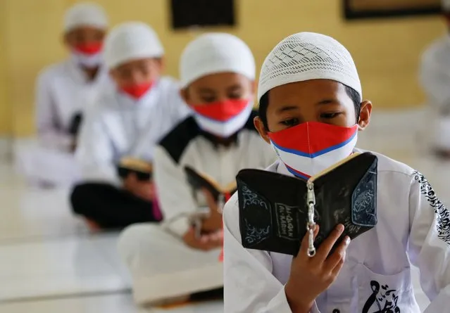 Muslim students wearing face masks practice social distancing while reading Koran at Daarul Qur'an Al Kautsar boarding school mosque, amidst the spread of the coronavirus disease (COVID-19) during the holy fasting month of Ramadan, in Bogor, West Java province, Indonesia, May 9, 2020. (Photo by Willy Kurniawan/Reuters)