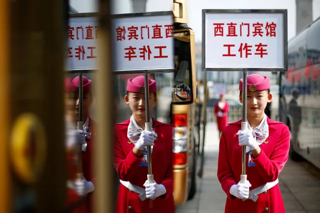 An usher holds a sign for a hotel for delegates returning from morning sessions on the second day of the 19th National Congress of the Communist Party of China the Great Hall of the People in Beijing, China on October 19, 2017. (Photo by Thomas Peter/Reuters)