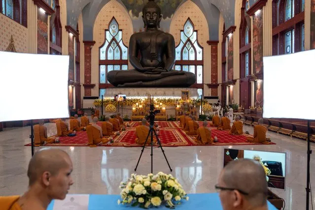 Buddhist monks broadcast through Facebook Live, amid concerns over the spread of coronavirus disease (COVID-19) during Vesak Day, an annual celebration of Buddha's birth, enlightenment and death at a temple in Bangkok, Thailand, May 6, 2020. (Photo by Athit Perawongmetha/Reuters)