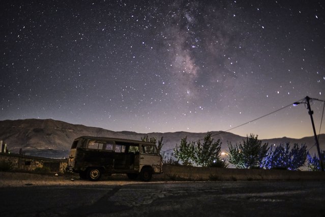 A long exposure picture taken early on August 28, 2022, shows a view of the Milky Way galaxy in the sky above a derelict van in the town of Bcahrre in the mountains of Lebanon, north  of the capital Beirut. (Photo by Ibrahim Chalhoub/AFP Photo)