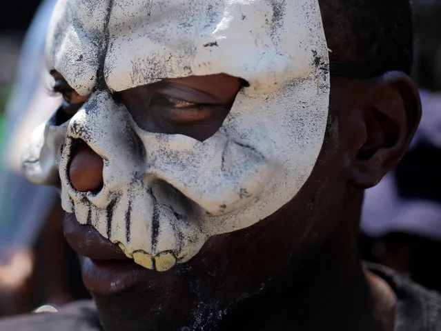 A protestor wears a mask during a protest organized by the HEALA (Healthy Living Alliance) outside the offices of the Coca Cola Company to mark World Diabetes Day in Johannesburg, South Africa, 14 November 2017. The group hopes to raise awareness to the amount of sugar used in many soft drinks. High sugar intake can lead to Diabetes. (Photo by  Kim Ludbrook/EPA/EFE)