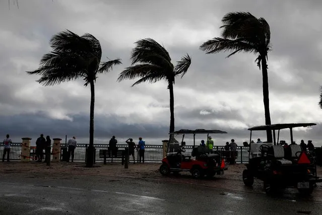 People look on from one of the access to the beach after Hurricane Nicole landfall at Vero Beach, Florida, on November 10, 2022. Tropical Storm Nicole slowed after making landfall in the US state of Florida, meteorologists said Thursday, with high winds raising concerns that a long-delayed NASA rocket launch could be disrupted. (Photo by Eva Marie Uzcategui/AFP Photo)