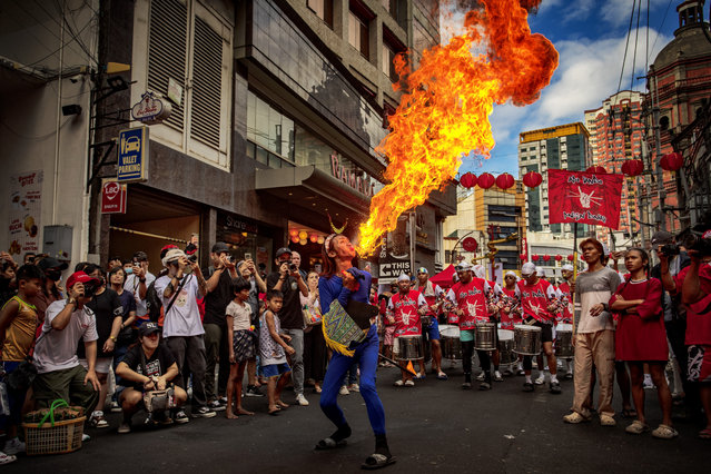 A performer breathes fire during Lunar New Year celebrations at Binondo district, considered the world's oldest Chinatown, on February 10, 2024 in Manila, Philippines. Lunar New Year, also known as Chinese New Year, is celebrated around the world, and the year of the Wood Dragon in 2024 is associated with growth, progress, and abundance, as wood represents vitality and creativity, while the dragon symbolizes success, intelligence, and honor. (Photo by Ezra Acayan/Getty Images)