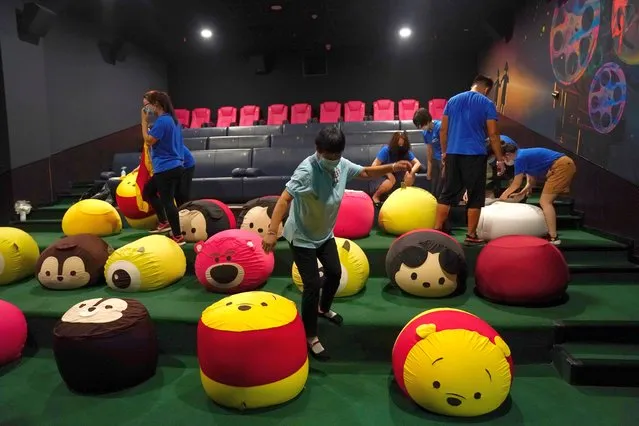 Staff members put covers on beanbags for kids at ACE cinema ahead of its reopening, following the coronavirus outbreak, in Beijing, China on July 28, 2020. (Photo by Tingshu Wang/Reuters)