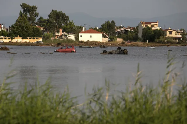 Sunken vehicles following a storm at the village of Bourtzi, on Evia island, northeast of Athens, on Sunday, August 9, 2020. Five people, including en elderly couple and an 8-month-old baby have been found dead, two more are missing and dozens have been trapped in their homes and cars as a storm hits the island of Evia in central Greece, authorities said Sunday. (Photo by Yorgos Karahalis/AP Photo)