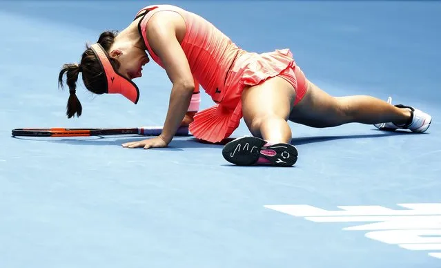 Lauren Davis of the US falls during their women' s singles third round match against Romania' s Simona Halep on day six of the Australian Open tennis tournament in Melbourne on January 20, 2018. (Photo by Thomas Peter/Reuters)