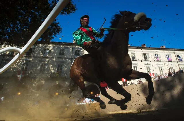 A horse and jockey take part in the Palio Di Asti, September 18, 2016 in Asti, Italy. The Palio di Asti is a traditional Italian festival of medieval origin that culminates in a bareback horse race. (Photo by Justin Setterfield/Getty Images)