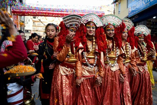 Participants from the Newar community, dressed in traditional attire, take part in the parade to mark Jyapu Day and Yamari Puni festival in Kathmandu, Nepal on December 8, 2022. (Photo by Monika Malla/Reuters)