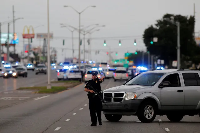 Police officers block off Airline Highway near the scene of a fatal shooting of police officers in Baton Rouge, Louisiana, United States, July 17, 2016. (Photo by Joe Penney/Reuters)