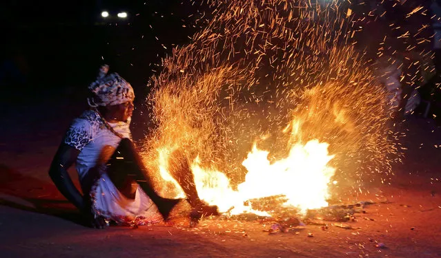 A member of the Maroon community, descendants of runaway slaves, performs the fire dance during the 3rd Poolo Boto (beautiful boat) competition as part of the Moengo Festival of Music in Marowijne district, northern Suriname, September 23, 2016. (Photo by Ranu Abhelakh/Reuters)