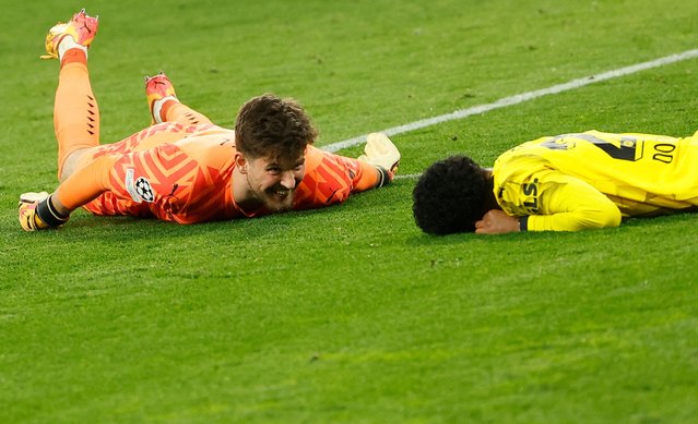 Dortmund's Swiss goalkeeper #01 Gregor Kobel (L) and Dortmund's German forward #27 Karim Adeyemi react after the final whistle of the UEFA Champions League quarter-final second leg football match between Borussia Dortmund and Atletico Madrid in Dortmund, western Germany on April 16, 2024. (Photo by Odd Andersen/AFP Photo)