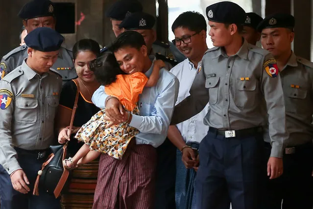 Detained Reuters journalist Kyaw Soe Oo hugs his daughter as he is escorted by police, arrives for a court hearing in Yangon, Myanmar, February 21, 2018. (Photo by Reuters/Stringer)