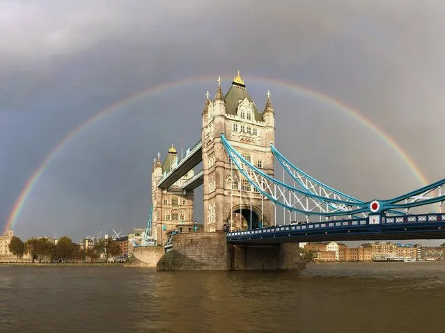 A view of a rainbow behind Tower Bridge in London, on November 1, 2014. (Photo by Paul Gilham/Getty Images)
