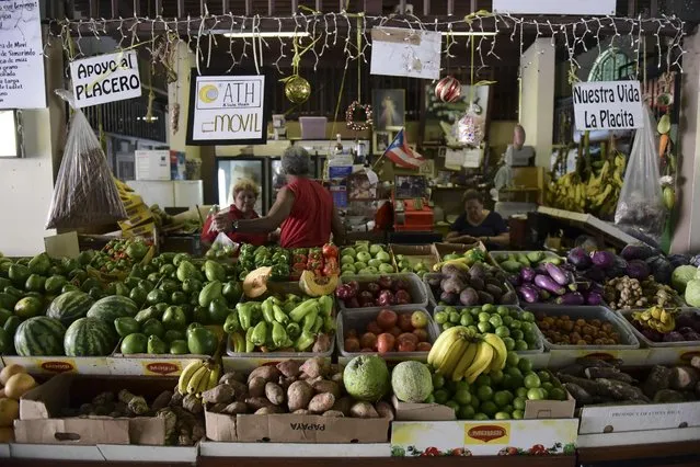 This September 23, 2016 photo shows a produce stand at La Placita de Santurce farmers' market that sells mostly locally grown produce in San Juan, Puerto Rico. The U.S. territory is seeing something of an agricultural renaissance as new farms spring up across the island, supplying an increasing number of farmers' markets and restaurants as consumers demand fresher produce. (Photo by Carlos Giusti/AP Photo)