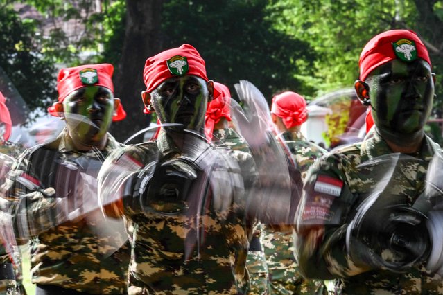 Cadets of the Komponen Cadangan (Komcad), the Reserve Component of the Indonesian National Armed Forces (TNI), take part in a graduation ceremony after three months of military basic training, in Banda Aceh on July 12, 2025. (Photo by Chaideer Mahyuddin/AFP Photo)