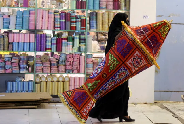 A Saudi woman shops for Ramadan decorations to mark the beginning of the Holy Month of Ramadan in a local market in Riyadh, Saudi Arabia on March 22, 2023. (Photo by Ahmed Yosri/Reuters)