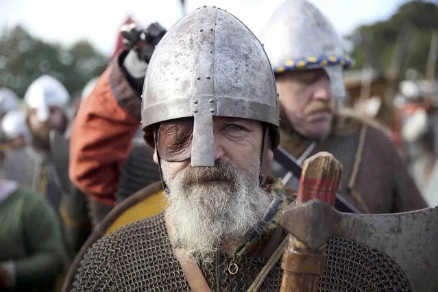 A re-enactor poses for a portrait before a re-enactment of the Battle of Hastings, commemorating the 950th anniversary of the battle, in Battle, Britain October 15, 2016. (Photo by Neil Hall/Reuters)