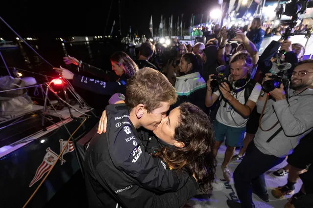 Team Malizia crew member Will Harris kisses his girlfriend after his team's arrival in the city of Itajai, Brazil, early on April 2, 2023, after completing the Cape Town – Itajai leg of The Ocean Race. (Photo by Anderson Coelho/AFP Photo)