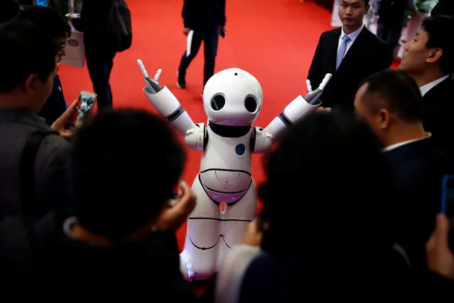 People look at a humanoid Urobot by Xiao Yanlin at the WRC 2016 World Robot Conference in Beijing, China, October 21, 2016. (Photo by Thomas Peter/Reuters)