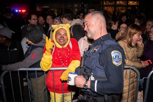 An attendee dressed as Winnie the Pooh talks with a member of the D.C. Metropolitan Police Department during the annual pre-Halloween High Heel Race in Washington, D.C., U.S., October 28, 2025. (Photo by Nathan Howard/Reuters)