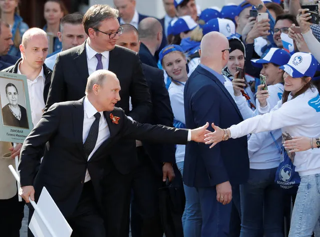 Russian President Vladimir Putin and his Serbian counterpart Aleksandar Vucic attend the Immortal Regiment march in Moscow, Russia on May 09, 2018. (Photo by Sergei Karpukhin/Reuters)
