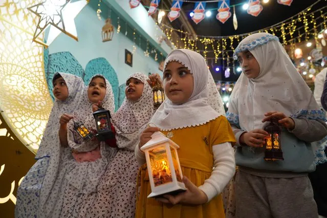 Children carrying lanterns roam the old city of Mosul, Iraq on March 22, 2023, to ​​celebrate the start of Ramadan. (Photo by Ismael Adnan/Al Jazeera)