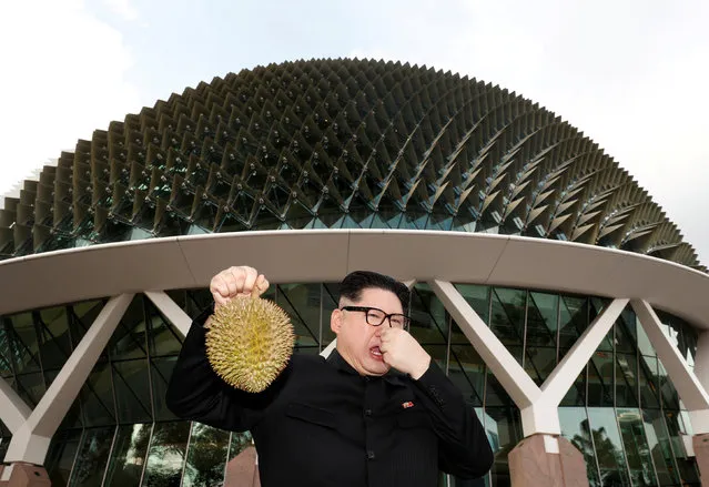 Howard, an Australian-Chinese impersonating North Korean leader Kim Jong Un, poses with a durian at the Esplanade in Singapore May 27, 2018. (Photo by Edgar Su/Reuters)