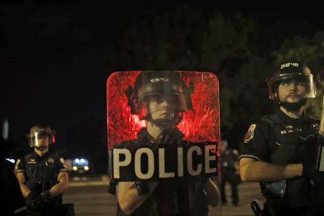 Metropolitan Police Department bicycle division officers stand guard after police closed the area around Lafayette Park near the White House after protesters tried to topple a statue of Andrew Jackson in the park in Washington, Monday, June 22, 2020. (Photo by Maya Alleruzzo/AP Photo)