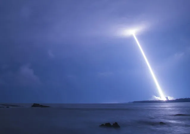 This photo taken on November 3, 2016 shows the blast trail of China's heavy-lift rocket Long March-5 as it launches from Wenchang, south China's Hainan province. China launched its most powerful rocket ever on November 3, state media said, as the country presses on with a program which has seen it become a major space power. (Photo by AFP Photo/Stringer)