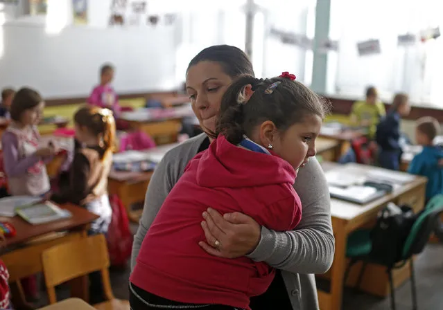 Ramela Meseljevic, a 7 year-old girl born without both of her hands and one of her legs shorter than the other, is carried back home by her mother Seherzada, after classes in the her school in Begov Han, Bosnia and Herzegovina December 2, 2015. (Photo by Dado Ruvic/Reuters)