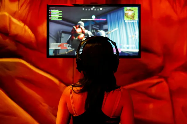 An attendee plays a video game at E3, the world's largest video game industry convention in Los Angeles, California on June 12, 2018. (Photo by Mike Blake/Reuters)