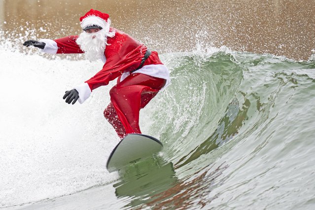 Instructor and life guard Finn Clark, from Gorebridge, dressed as Santa Claus for a surfing session at the Lost Shore Surf Resort in Newbridge, near Edinburgh on Tuesday, December 23, 2025. (Photo by Jane Barlow/PA Wire)