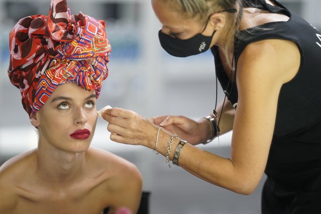 A model is seen on the backstage before the presentation of Spanish designer Agatha Ruiz de la Prada's creations during the Mercedes Benz Fashion Week, amid the coronavirus disease (COVID-19) outbreak, in Madrid, Spain, September 10, 2020. (Photo by Juan Medina/Reuters)