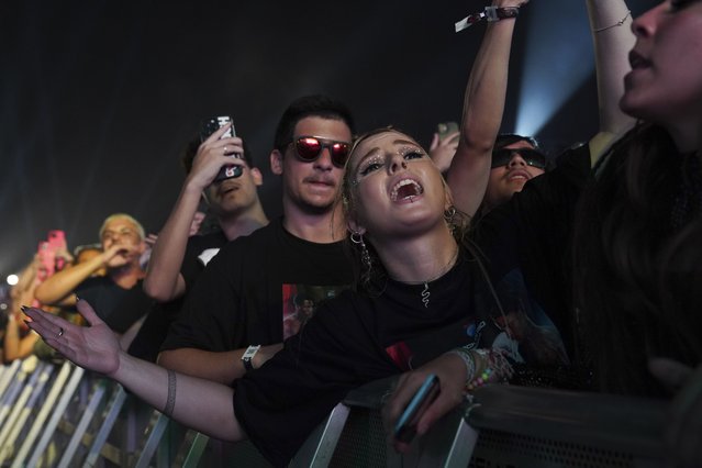 A festival-goer sings at Rock in Rio music festival while Brazilian rappers Veigh and Kayblack perform in Rio de Janeiro, Friday, September 13, 2024. (Photo by Hannah-Kathryn Valles/AP Photo)