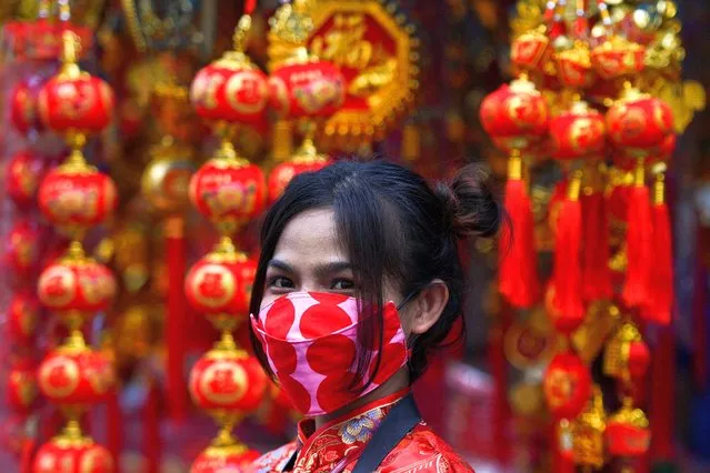 A woman wearing a face mask looks on ahead of the Lunar New Year celebration at the Chinatown in Bangkok, Thailand, February 10, 2021. (Photo by Chalinee Thirasupa/Reuters)
