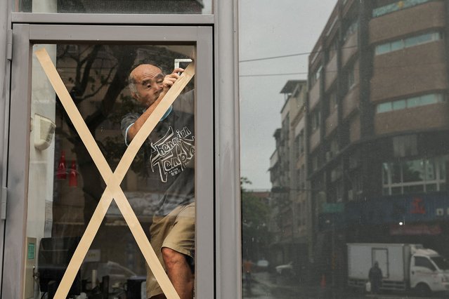 A resident prepares for Typhoon Krathon, in Kaohsiung, Taiwan on October 1, 2024. (Photo by Ann Wang/Reuters)