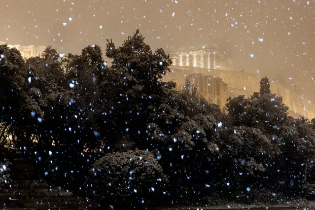 The ancient Parthenon temple on the Acropolis hill is illuminated during a snowfall in central Athens, early Tuesday, February 16, 2021. (Photo by Marios Lolos/Imago)