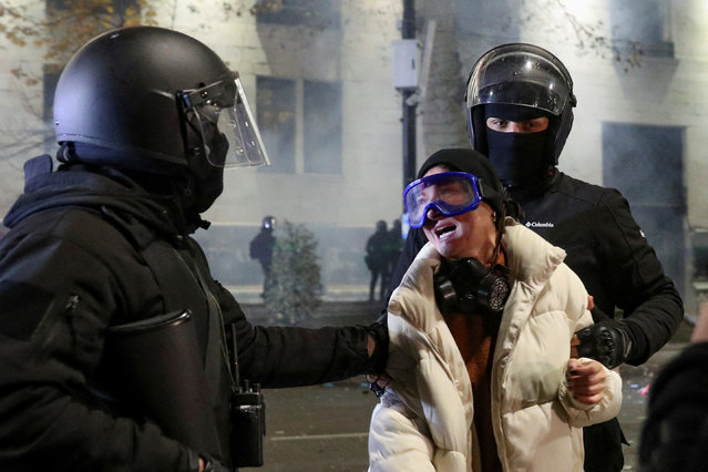 Law enforcement officers grab a person as supporters of Georgia's opposition parties hold a rally, to protest against the government's decision to suspend talks on joining the European Union, in Tbilisi, Georgia on December 3, 2024. (Photo by Irakli Gedenidze/Reuters)