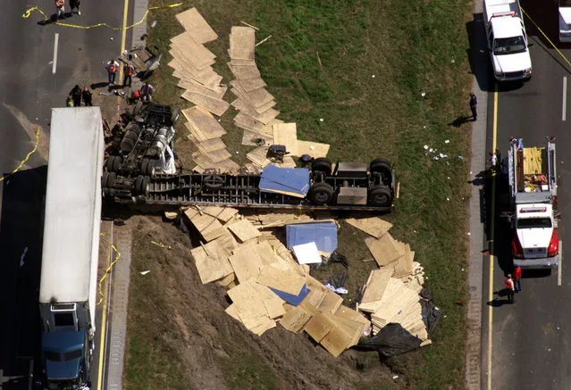 Plywood is strewn on the ground after more than a dozen cars and a truck carrying 200 barrels of acid collided, on Interstate 10 near Welborne, Florida March 8, 2000. (Photo by Joe Skipper/Reuters)